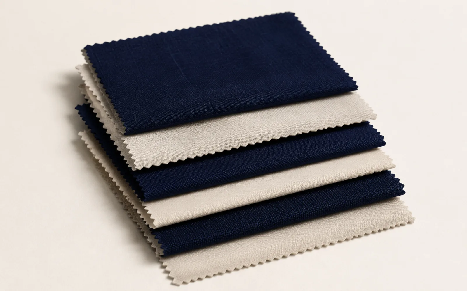 Folded fabric swatches in navy and ivory